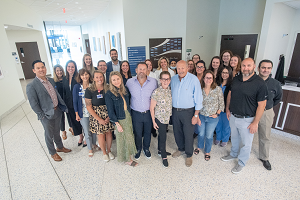 The Finsilver family poses for a photo with the OncoStat team in front of the new Shari and Stanley Finsilver and Family OncoStat sign in this photo provided by Henry Ford Health.